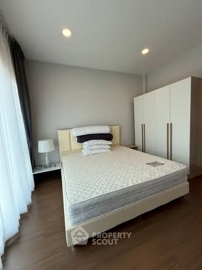 Modern bedroom with sleek design and ample natural light