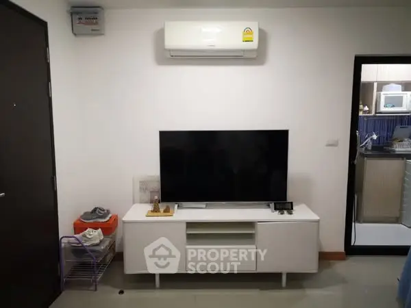 Modern living room with sleek TV setup and air conditioning unit