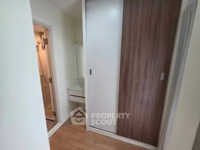 Modern apartment interior with sleek closet and adjacent bathroom