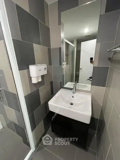 Modern bathroom with sleek sink and stylish tile design