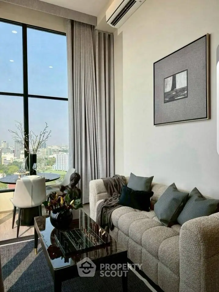Luxurious living room with stunning city view, elegant decor, and modern furnishings.