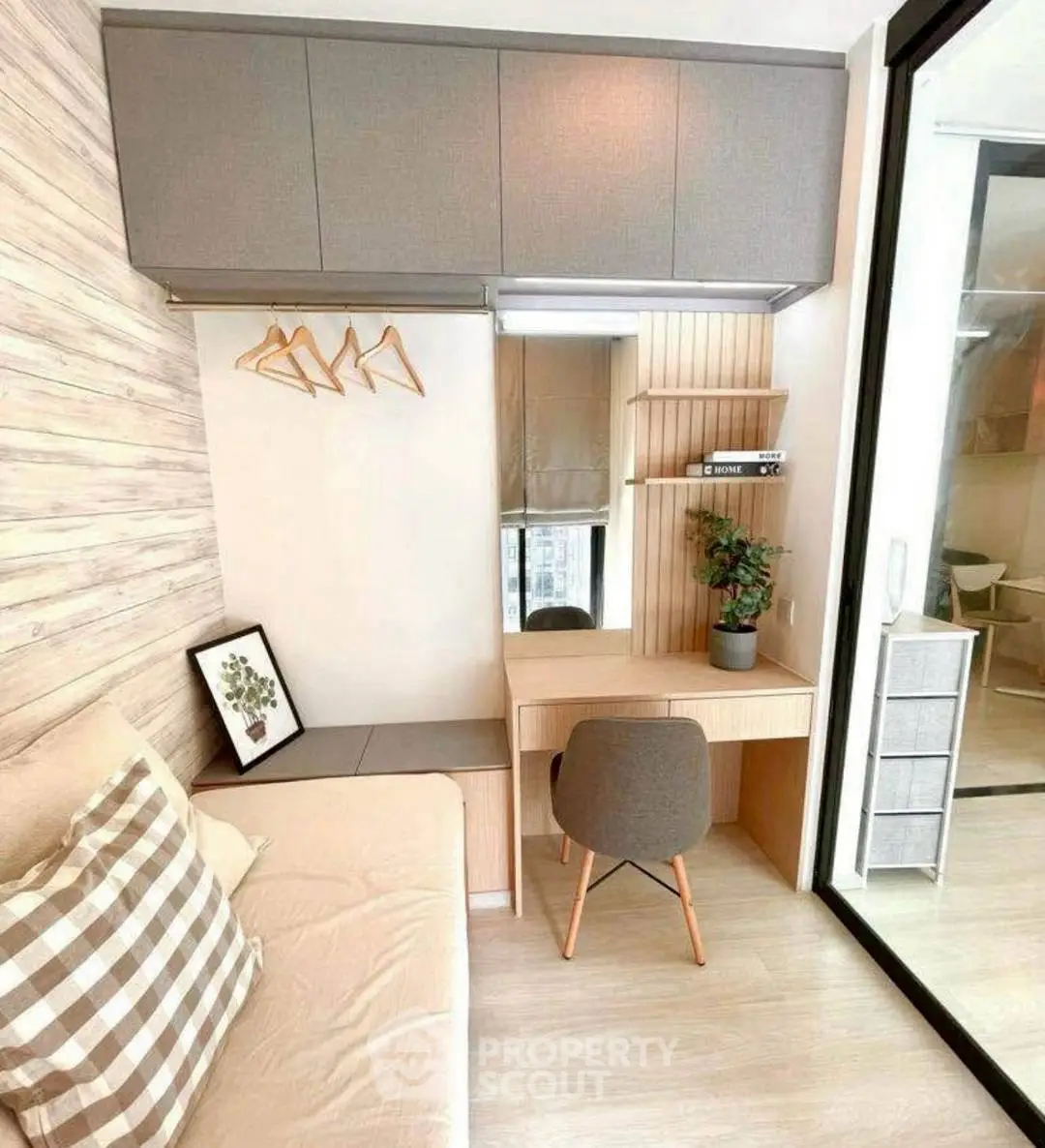 Modern study nook with desk, chair, and storage in cozy apartment.
