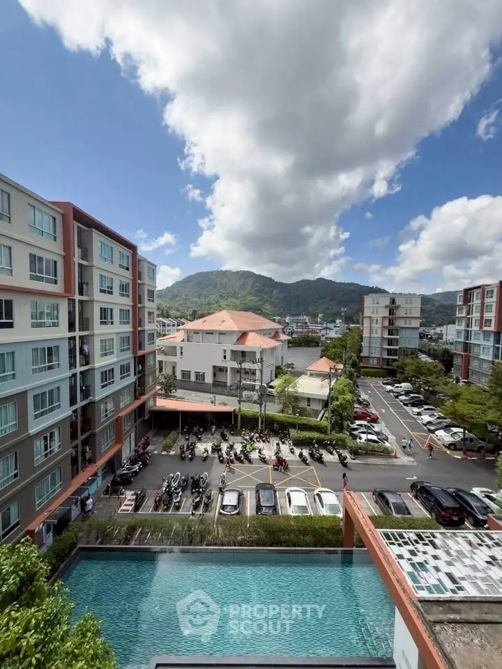Stunning view of modern apartment complex with pool and mountain backdrop