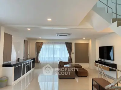 Spacious modern living room with sleek design and large windows