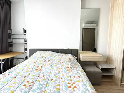 Modern bedroom with stylish decor and ample natural light