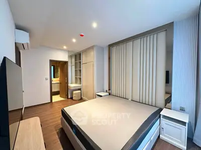 Modern bedroom with sleek design and ensuite bathroom in a stylish apartment