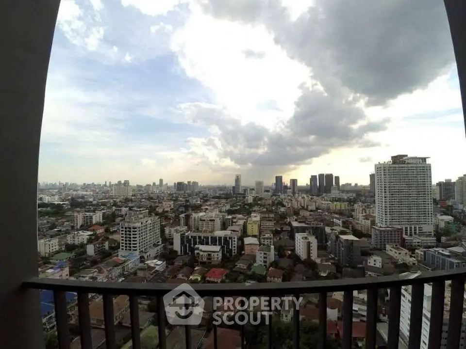 Stunning cityscape view from a high-rise balcony overlooking urban skyline.