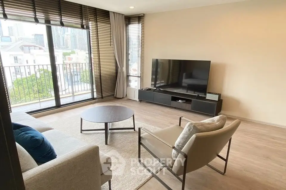 Spacious modern living room with large windows and city view