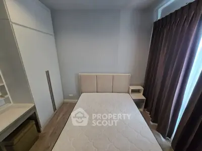 Cozy bedroom with modern furniture and natural light, perfect for relaxation.