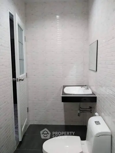 Modern bathroom with sleek sink and toilet in minimalist design