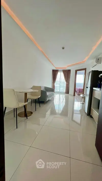 Modern living room with sleek design and natural light, featuring a cozy sofa and elegant dining area.