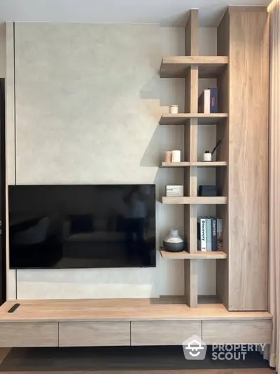 Modern living room with stylish wooden TV unit and shelving