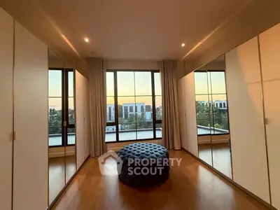 Luxurious bedroom with mirrored closets and stunning sunset view.
