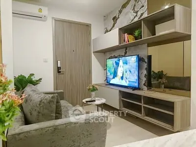 Modern living room with stylish decor and wall-mounted TV, perfect for relaxation and entertainment.
