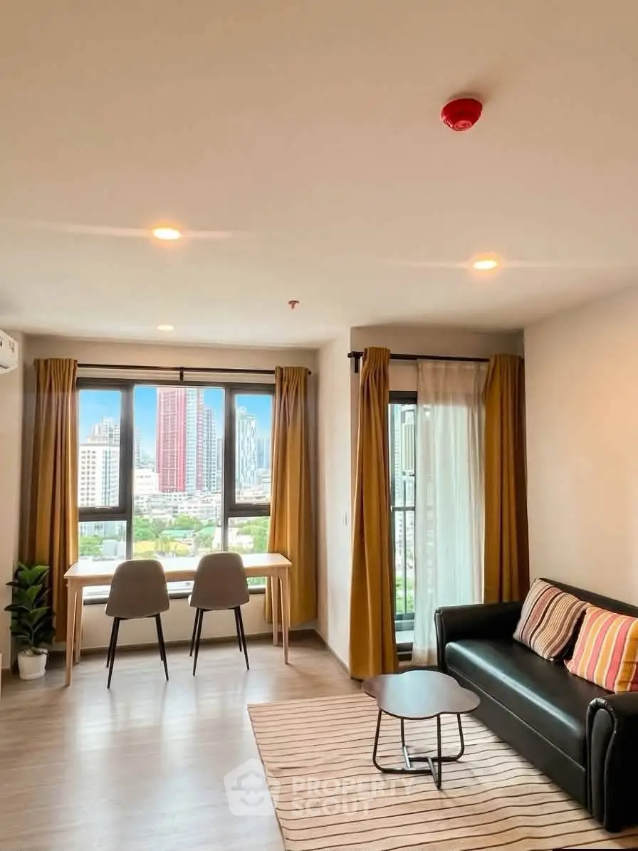 Modern living room with city view, stylish furniture, and natural light in urban apartment.