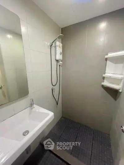 Modern bathroom with sleek shower and minimalist design, perfect for urban living.