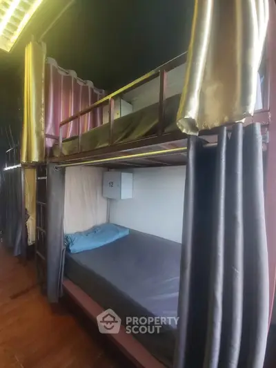 Cozy shared bedroom with bunk beds and privacy curtains in modern apartment.