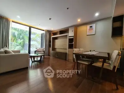 Spacious living room with elegant wooden flooring and modern furniture