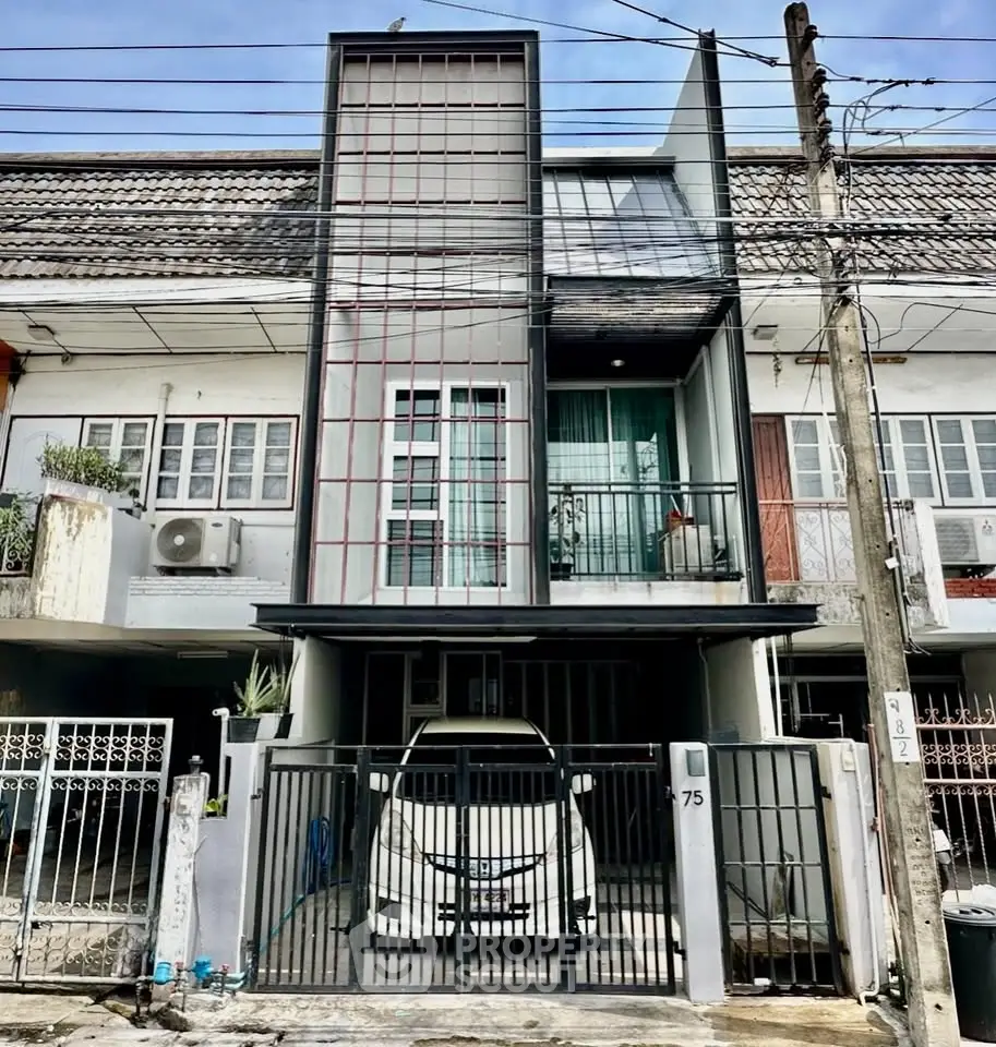 Modern townhouse with unique facade and secure parking in urban neighborhood.