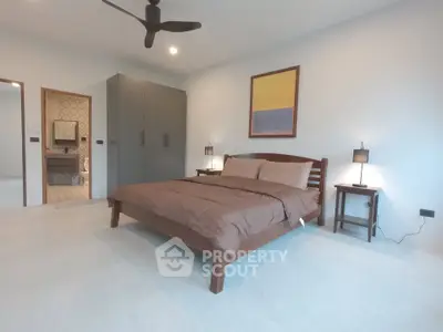 Spacious modern bedroom with ensuite bathroom and stylish decor