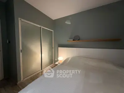 Cozy bedroom with modern sliding closet doors and ambient lighting