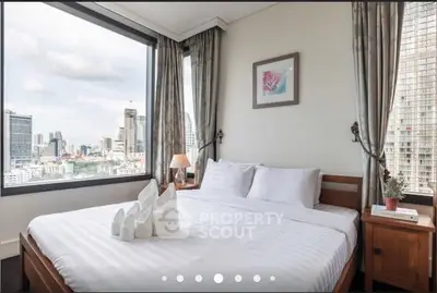 Luxurious bedroom with stunning city view and elegant decor