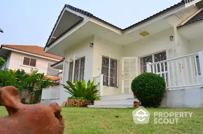 Charming single-story home with lush garden and inviting porch in a serene neighborhood.