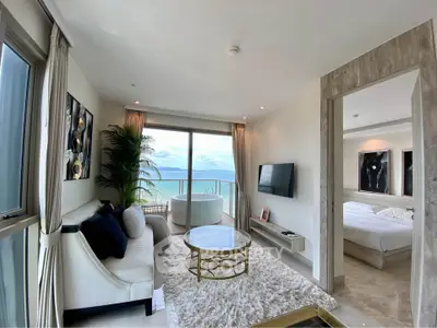 Luxurious beachfront living room with stunning ocean view and elegant decor.