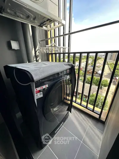 Modern balcony with washing machine and city view, perfect for urban living convenience.