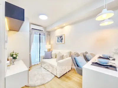 Chic modern living room with cozy sofa and elegant dining area in bright apartment.