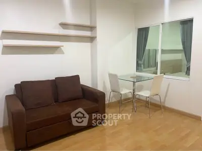 Cozy living room with brown sofa and glass dining table in modern apartment