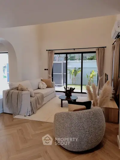 Stylish living room with modern furniture and garden view, perfect for relaxation and entertaining.