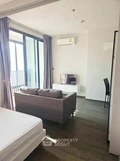 Modern living room with balcony access and sleek furniture