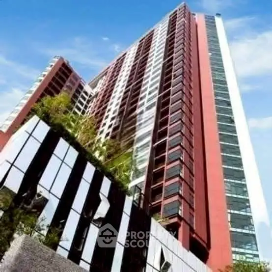Stunning modern high-rise building with sleek architectural design and lush greenery.