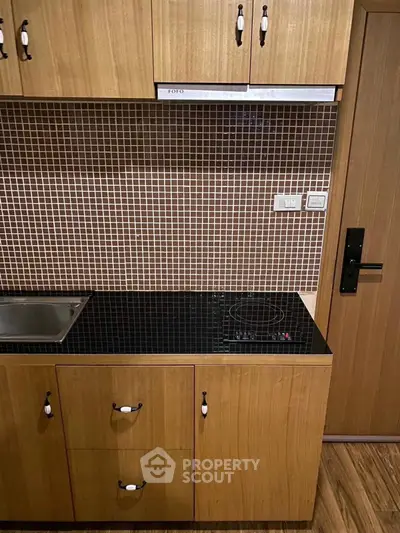 Modern kitchen with sleek wooden cabinets and electric stove