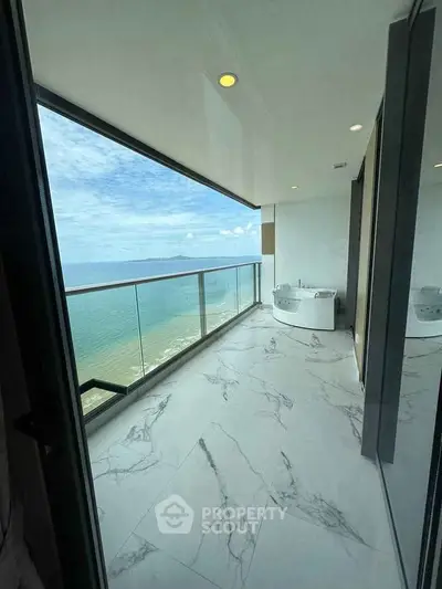 Luxurious balcony with stunning ocean view and elegant marble flooring.
