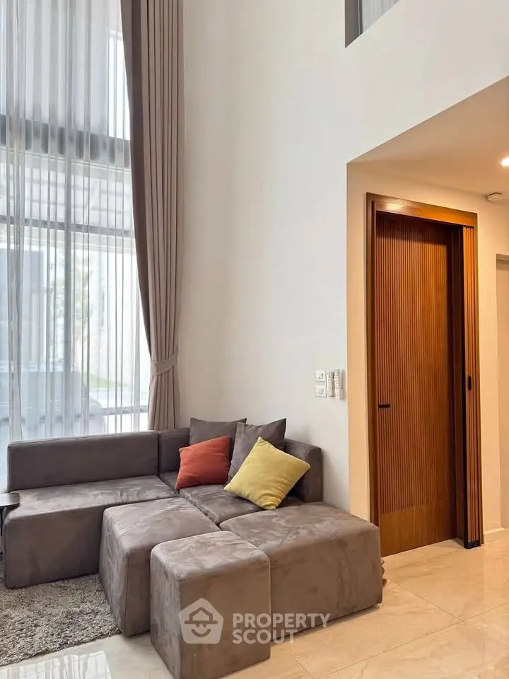 Luxurious living room with high ceilings and modern furniture in a stylish home.