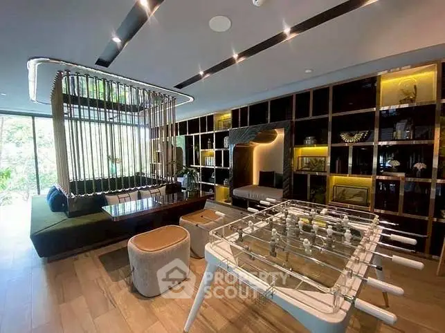 Luxurious living room with modern decor and foosball table, perfect for entertainment.