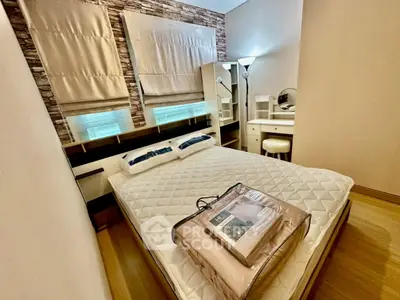 Cozy bedroom with stylish decor and natural light, featuring a comfortable bed and elegant furnishings.