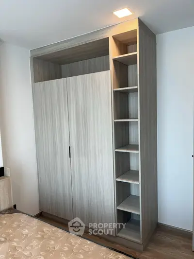 Modern bedroom with sleek wooden wardrobe and cozy bed