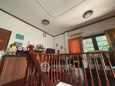 Charming interior with wooden staircase and cozy living area, perfect for family gatherings.