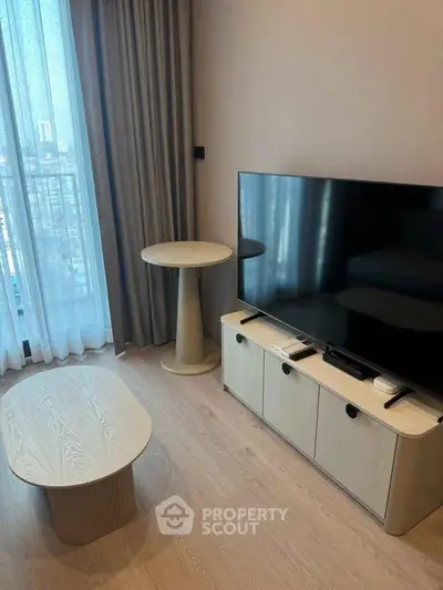 Modern living room with sleek TV setup and stylish furniture, perfect for urban living.