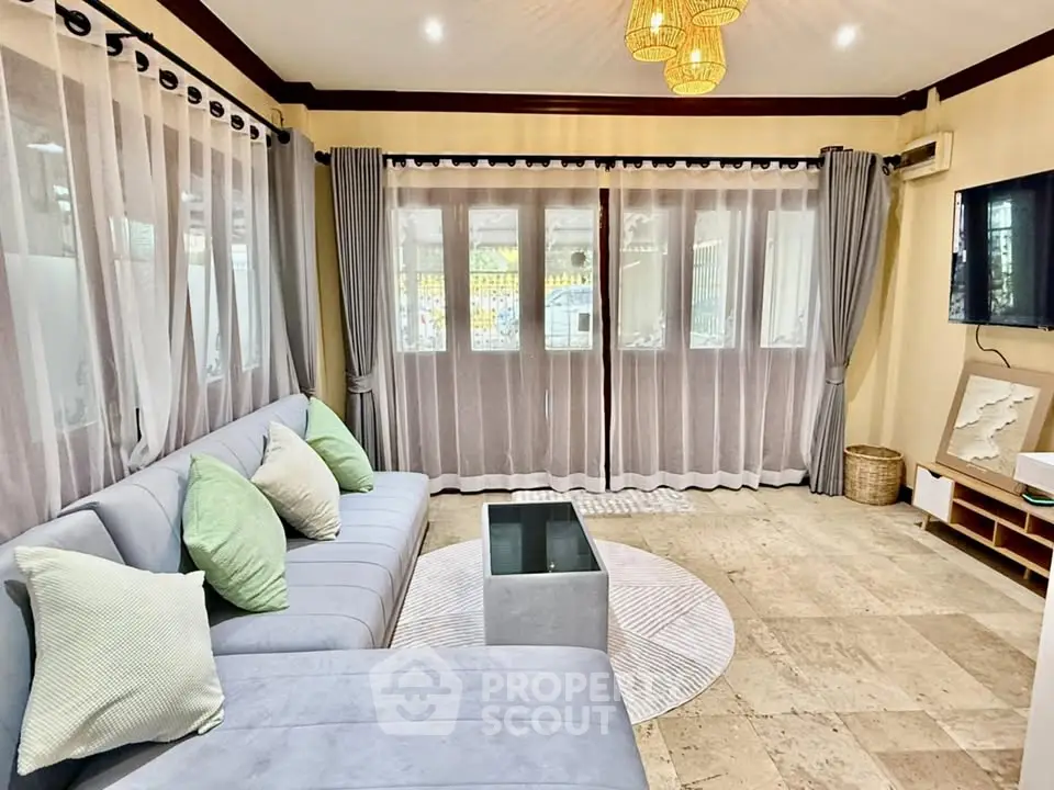 Spacious living room with modern decor and large windows for natural light