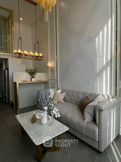 Luxurious living room with elegant chandelier and plush sofa in modern apartment