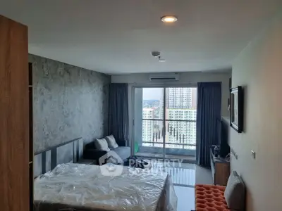 Modern bedroom with balcony view in high-rise apartment