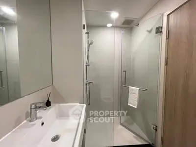 Modern bathroom with glass shower and sleek sink design