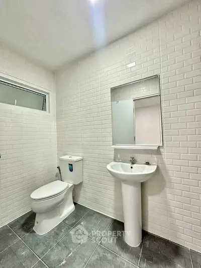 Modern bathroom with sleek white tiles and minimalist fixtures