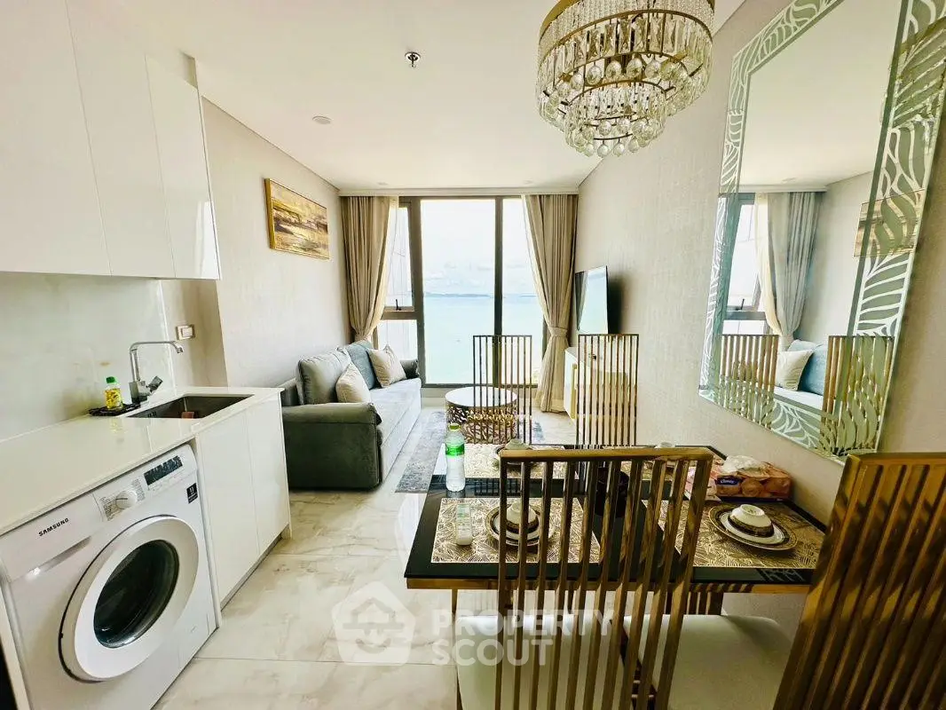 Luxurious living room with stunning sea view, elegant decor, and modern amenities in a high-end apartment.