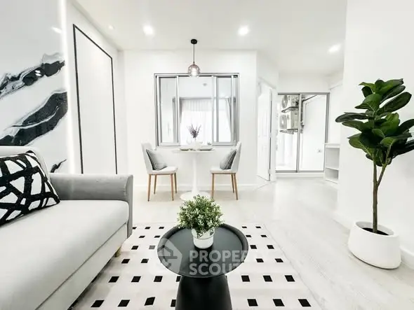Modern living room with stylish decor and natural light, featuring a cozy seating area and elegant dining space.