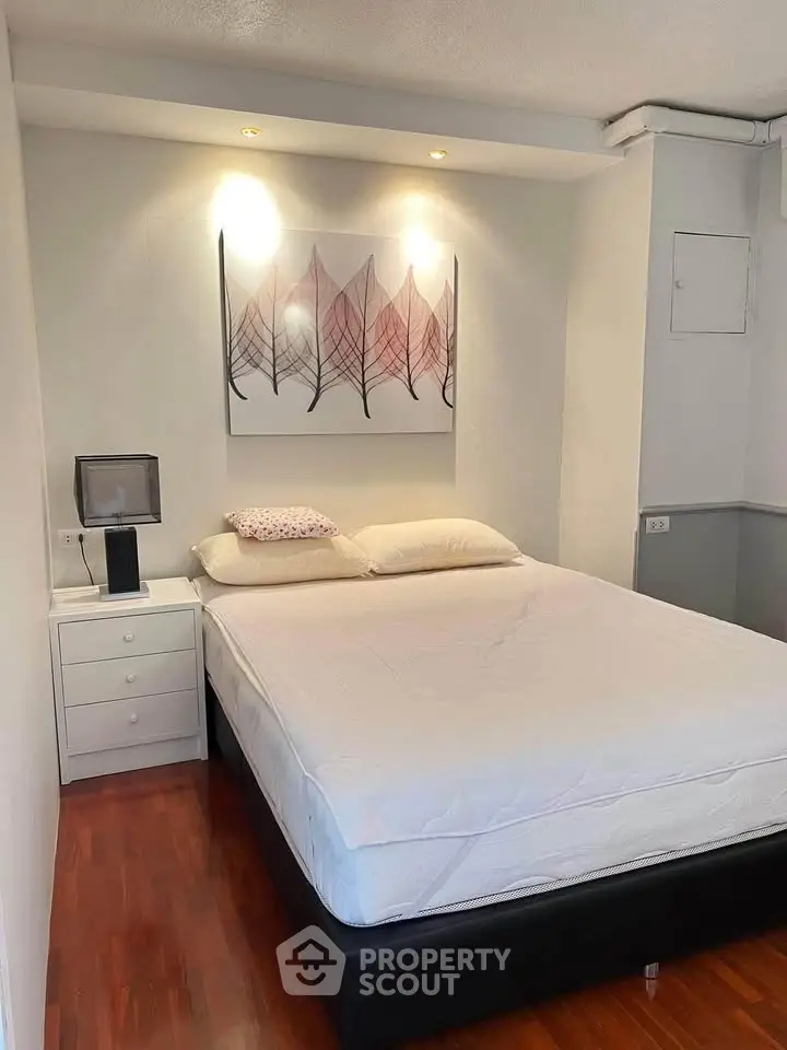 Cozy bedroom with modern decor and wooden flooring